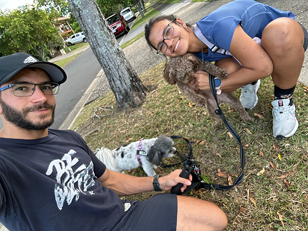 Two persons walking with dogs